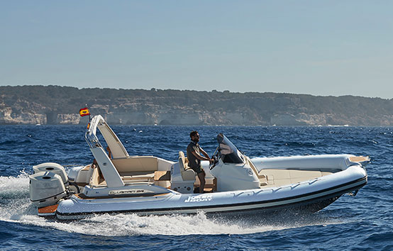 Man driving white inflatable boat on ocean